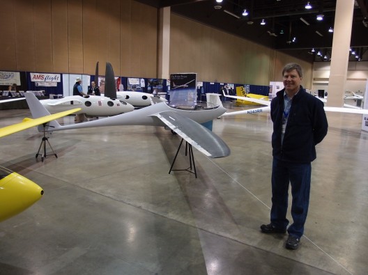 Greg Cole proudly displays Duckhawk at 2012 Soaring Society of America convention.  Note the Designer's Perlan cockpit mockups in background
