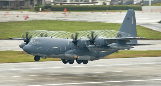 C-130J's six-bladed propellers making quiet swirls on a humid takeoff