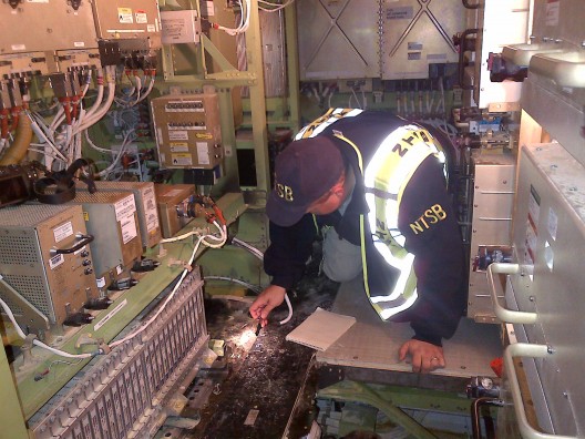 NTSB investigator Mike Bauer examines aftermath of main battery fire