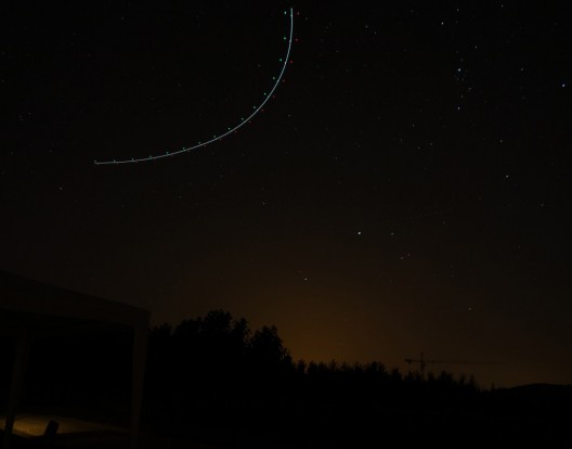 Navigation lights form arc in night sky 