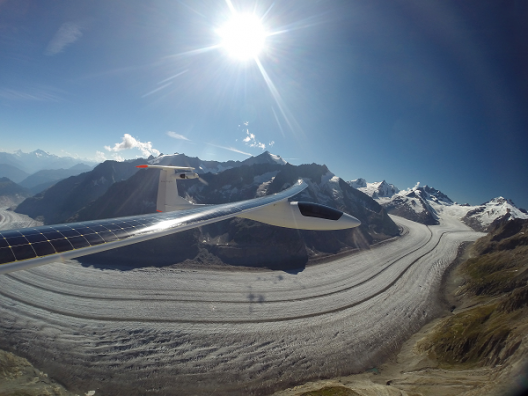 Brilliant alpine sun, ancient glacier, the future of flight all in one scene